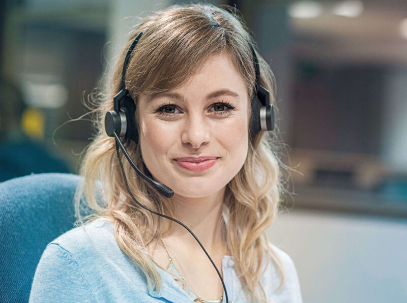 Image of smiling woman working at Simply Headsets