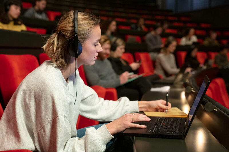 Image of female student wearing ADAPT 100 Mobile Headset