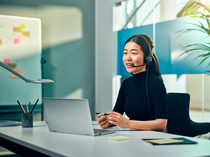 Image of woman in office wearing EPOS IMPACT 200 headset