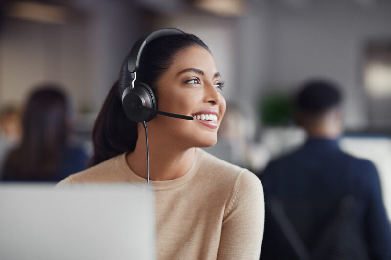 Image of woman wearing headset and smiling