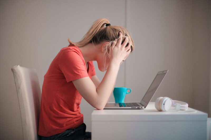 Image of Frustrated woman looking at laptop computer