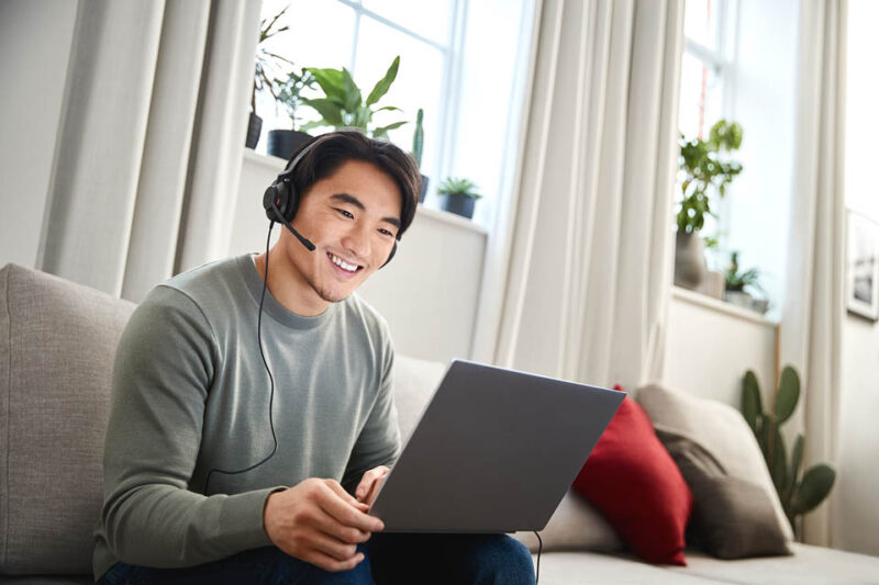 Image of man wearing computer mono headsets