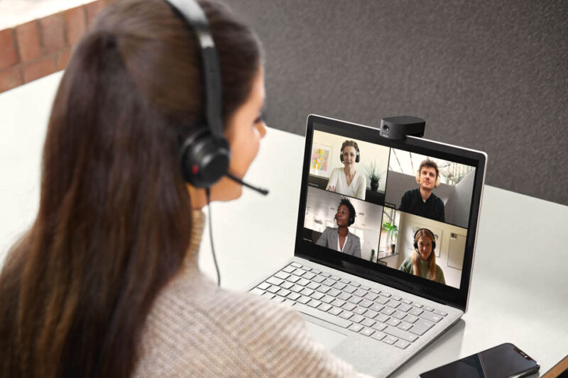 Woman on conference call wearing headset using jabra panacast 20 webcam