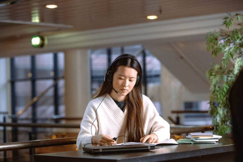 image of female student studying with headset