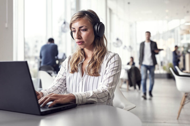 Image of woman wearing active noise cancelling headset concentrating