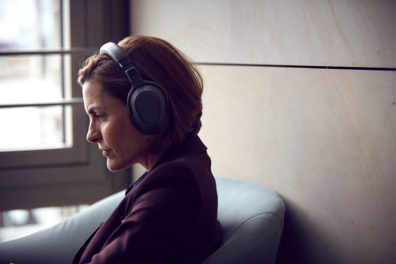 Woman concentrating while wearing full sized headphones