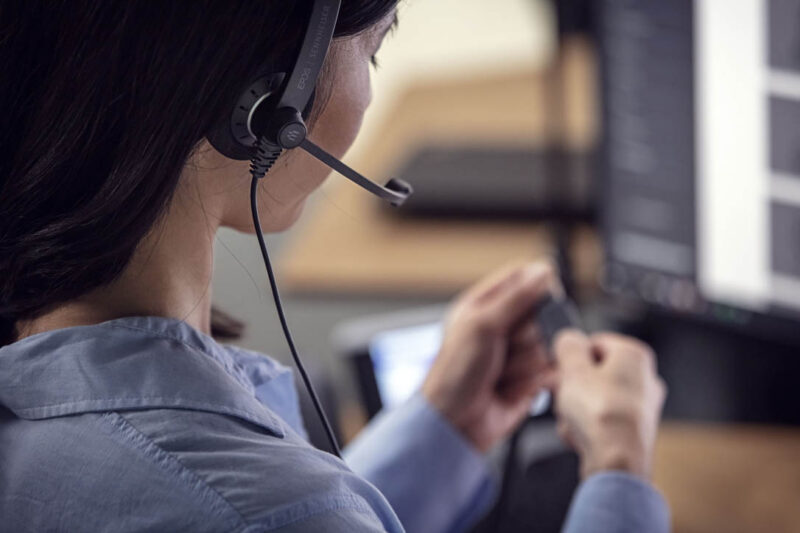 Woman wearing a headset adjusting the controls