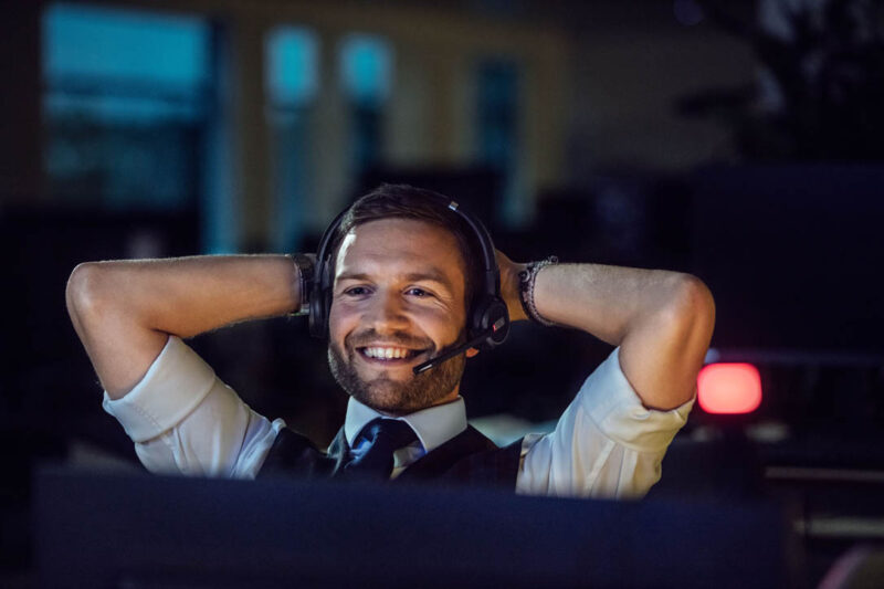 Image of man with headset smiling