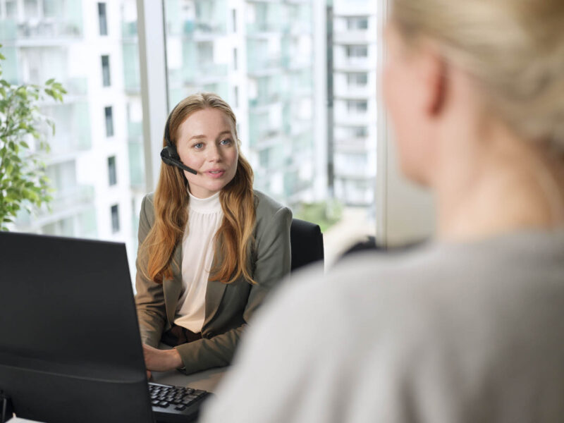 Image of woman wearing headset in office