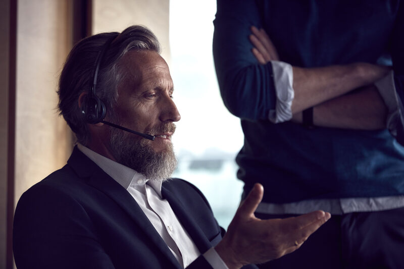 Man wearing wireless headset on a call