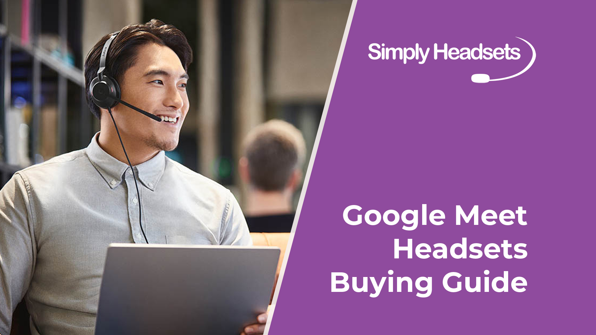 Man wearing Google Meet headset working on laptop and smiling