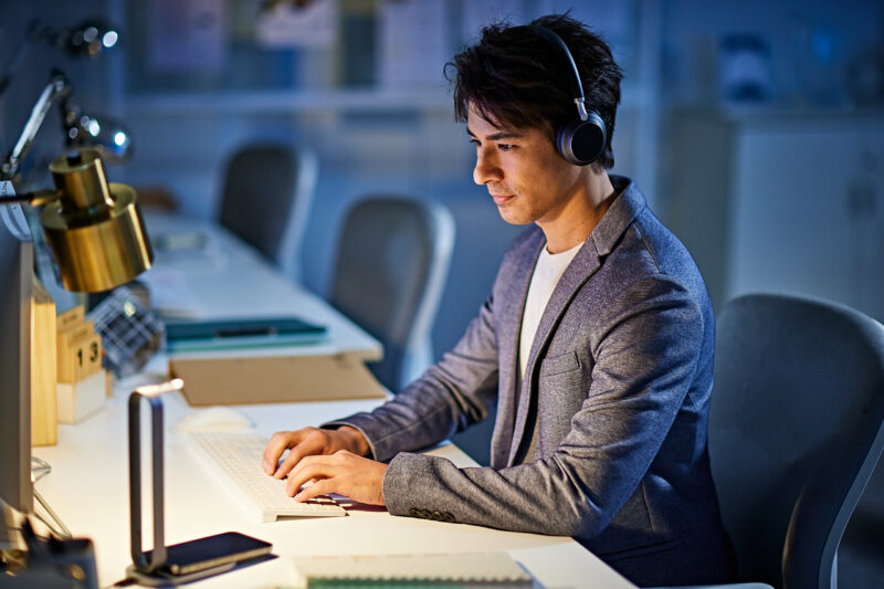 Man wearing wireless Yealink headset concentrating at work