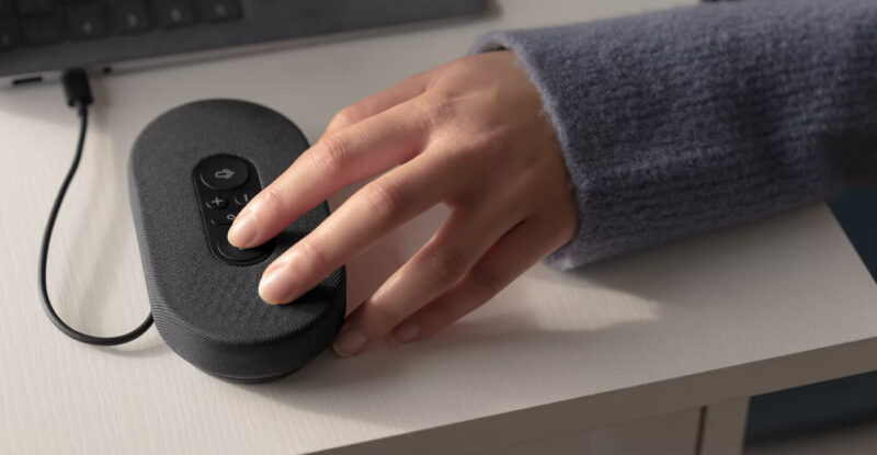Hand touching Microsoft Modern USB-C Speaker