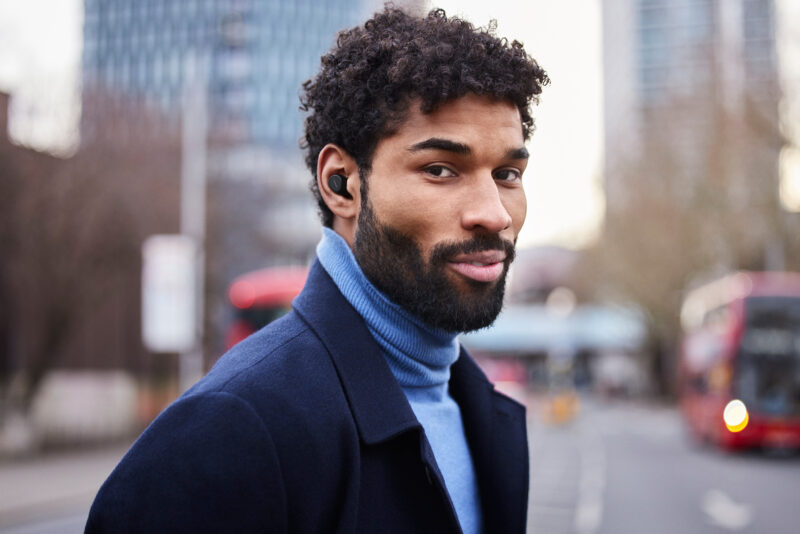 man on street wearing an in ear headset