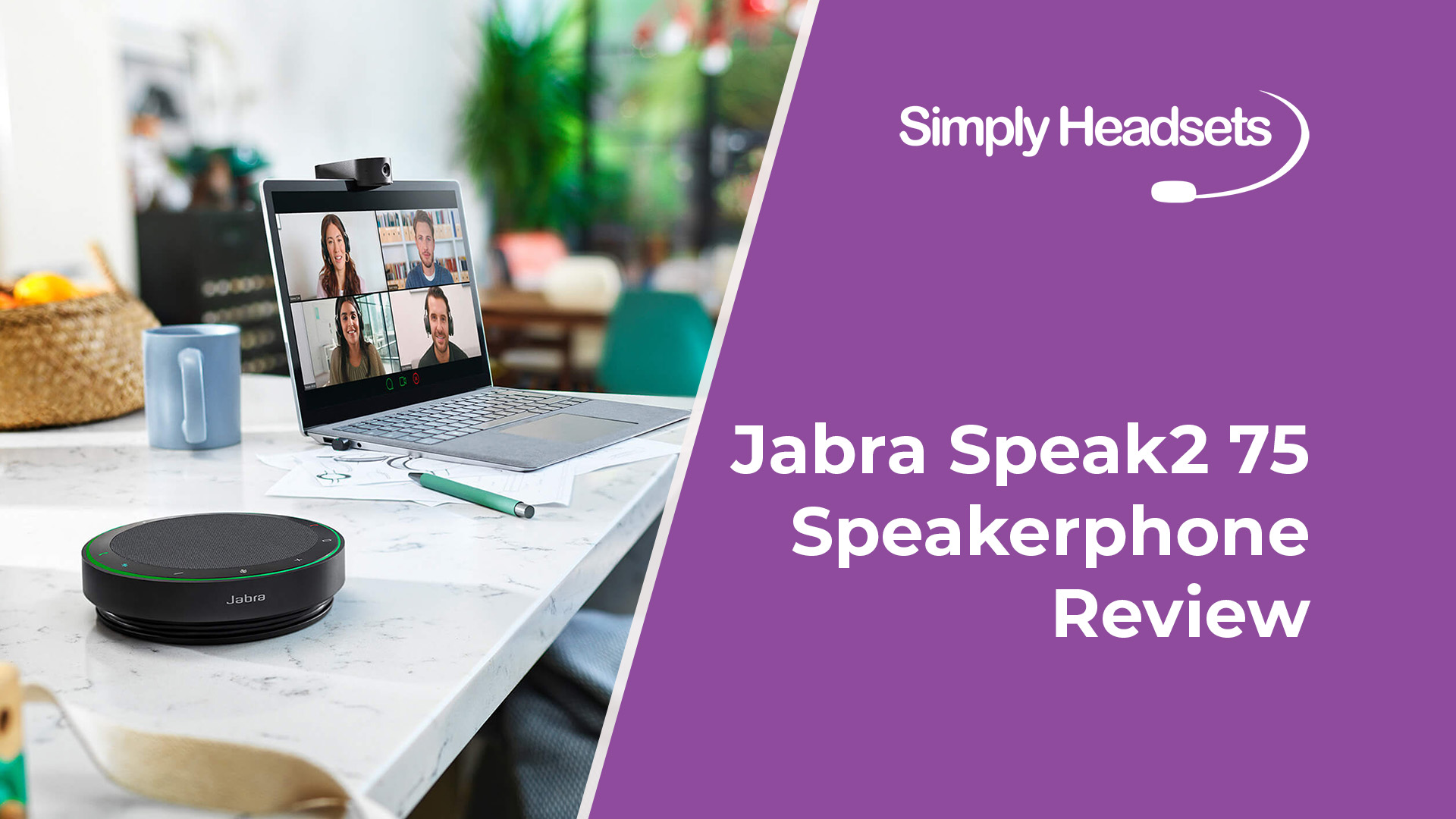 Jabra Speak2 75 speakerphone on desk next to laptop